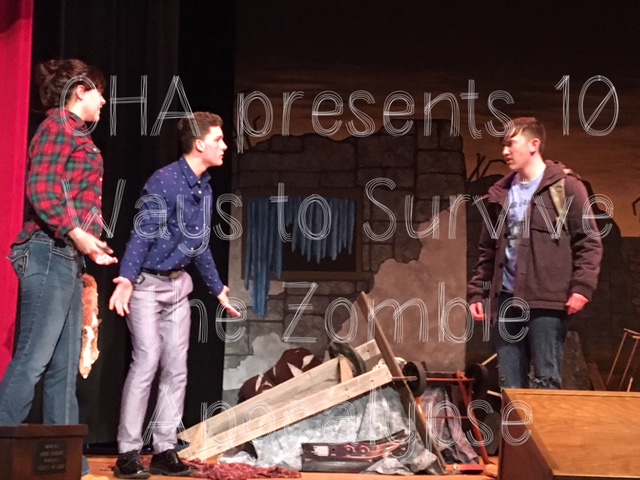 Three students on stage during a play