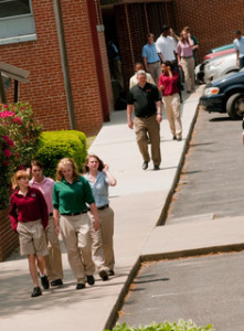 students and teachers walking down the sidewalk at oak hill