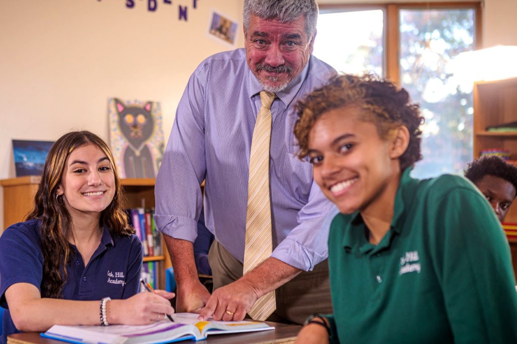 teacher with two students smiling