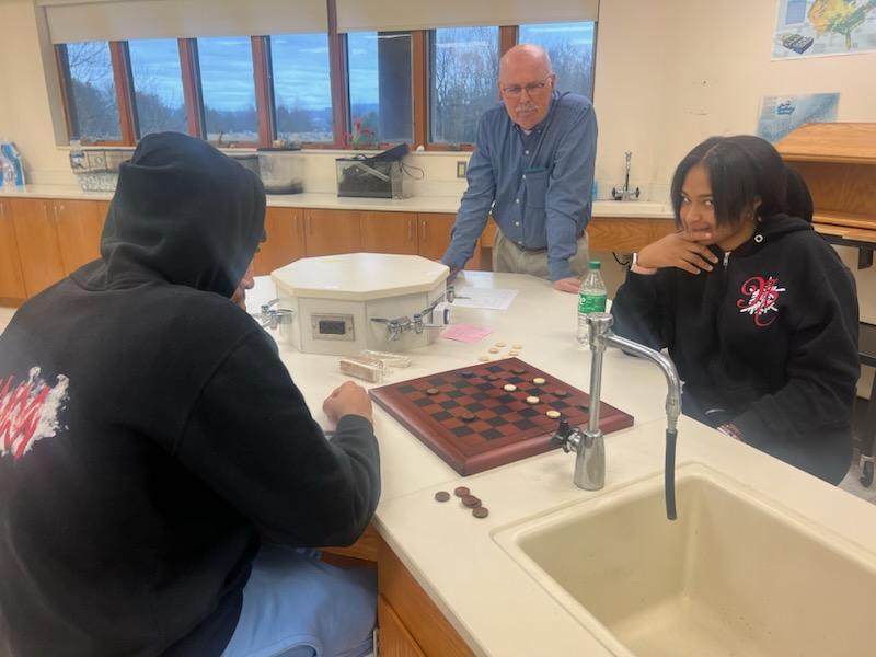 Students play checkers as part of spirit day festivities